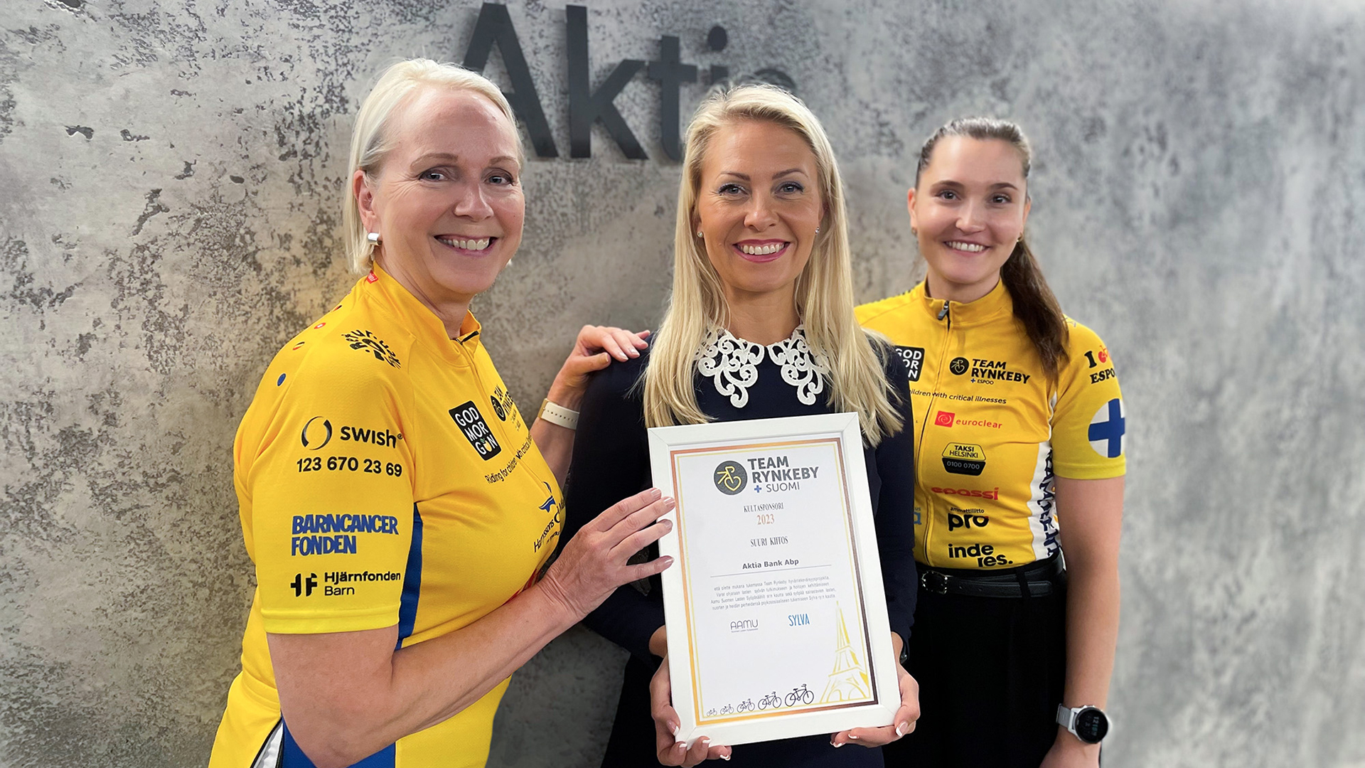 Aktialaiset Team Rynkeby-pyöräilyseuran jäsenet ja Anna Holtari vastaanottavat diplomin
